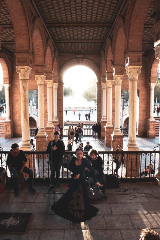 woman in black dress in arch building